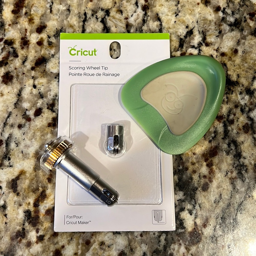 Two Cricut scoring wheel tips